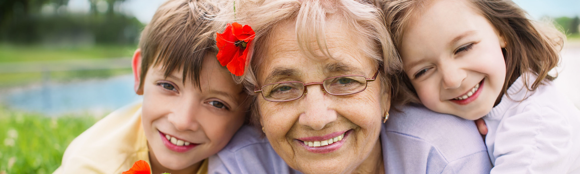 happy grandmother with grandchildren outdoors Closeup summer portrait of happy grandmother with grandchildren outdoors